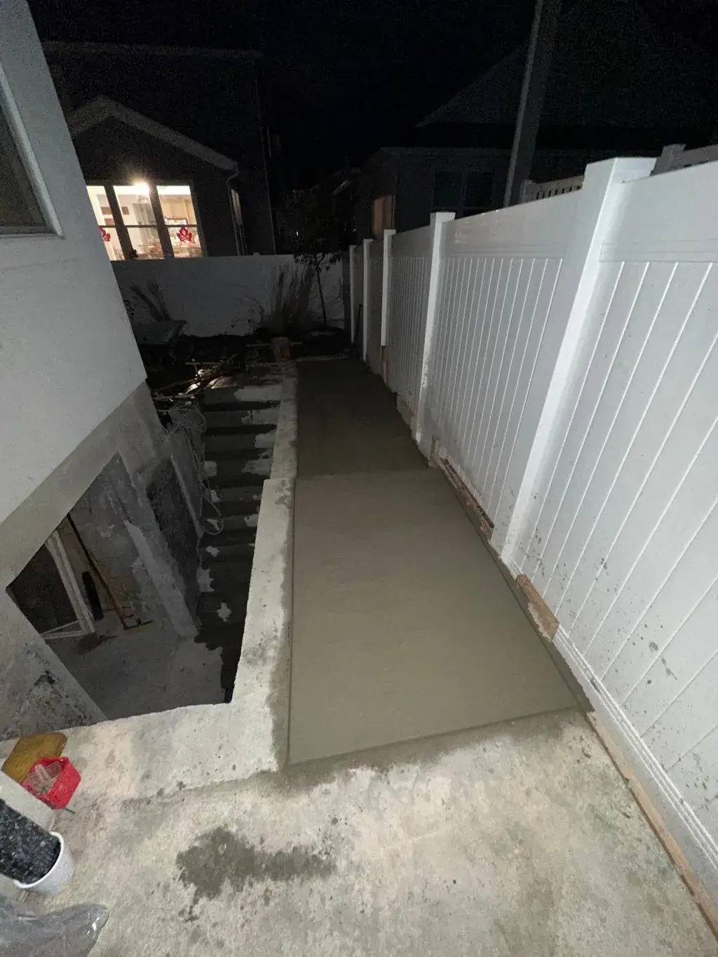 Side yard path poured next to basement steps by MD Concrete in Utah