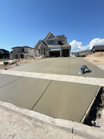 Crew finishing a new driveway by MD Concrete in Utah