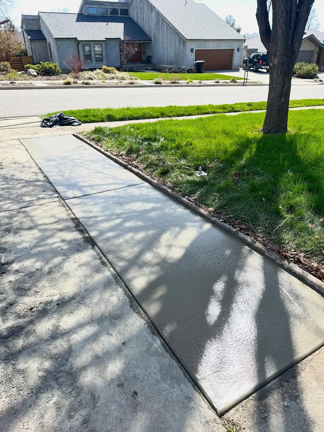 New concrete sidewalk along a home by MD Concrete in Utah