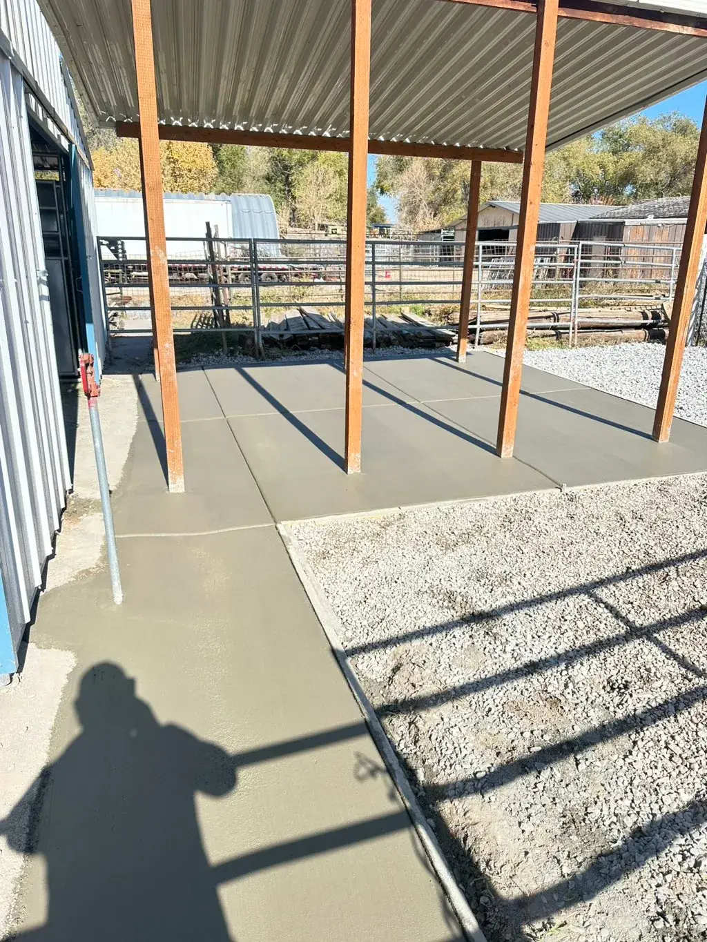 Covered patio slab beside a home by MD Concrete in Utah
