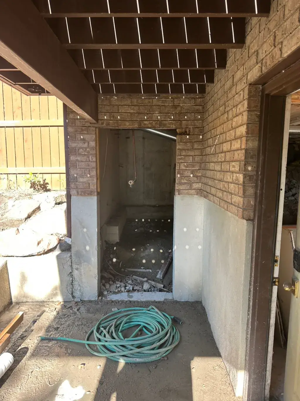 Walkout entry under a deck by MD Concrete in Utah
