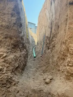 Trench dug beside a home by MD Concrete in Utah