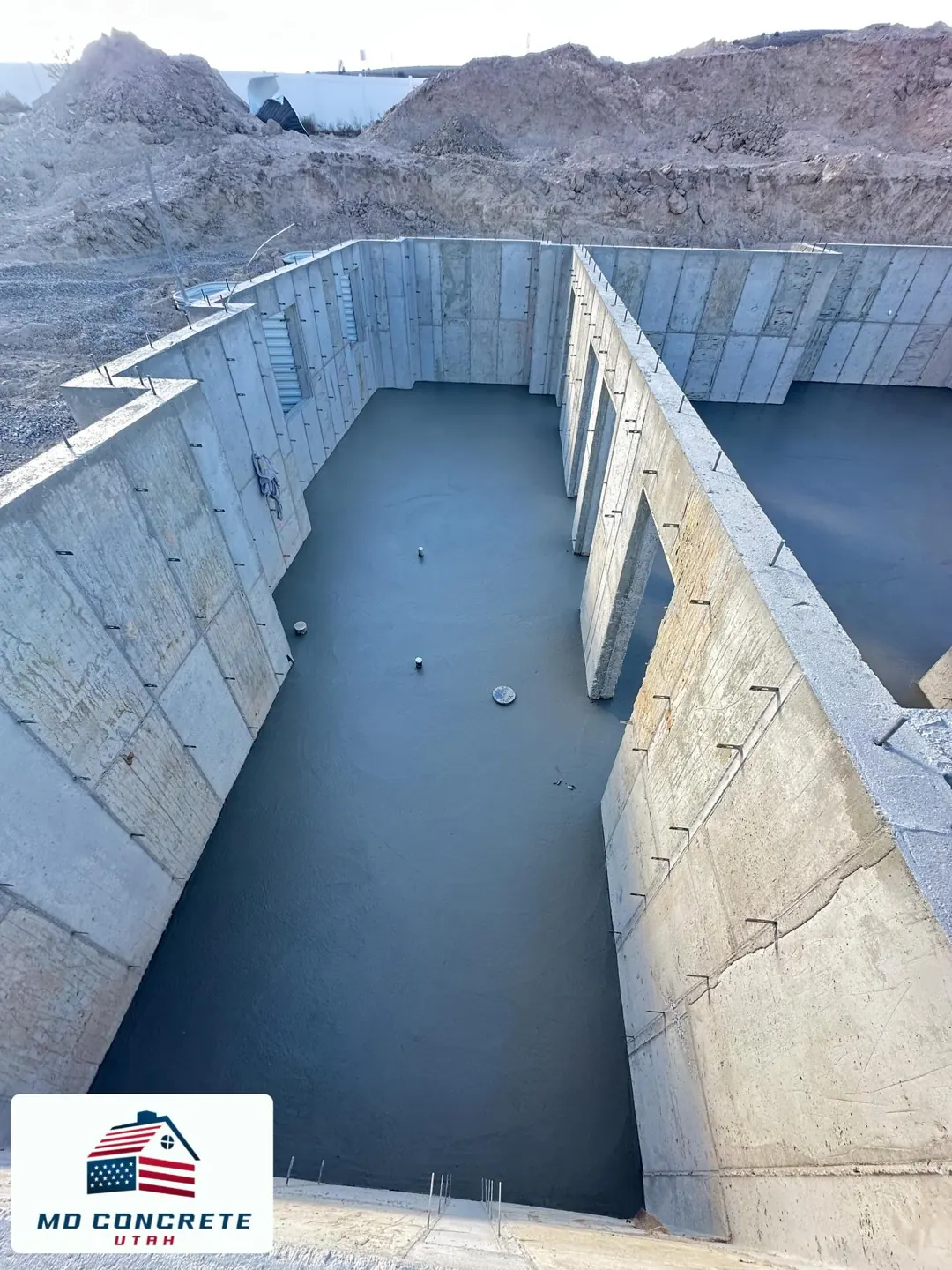 Concrete walls and a fresh basement floor by MD Concrete in Utah