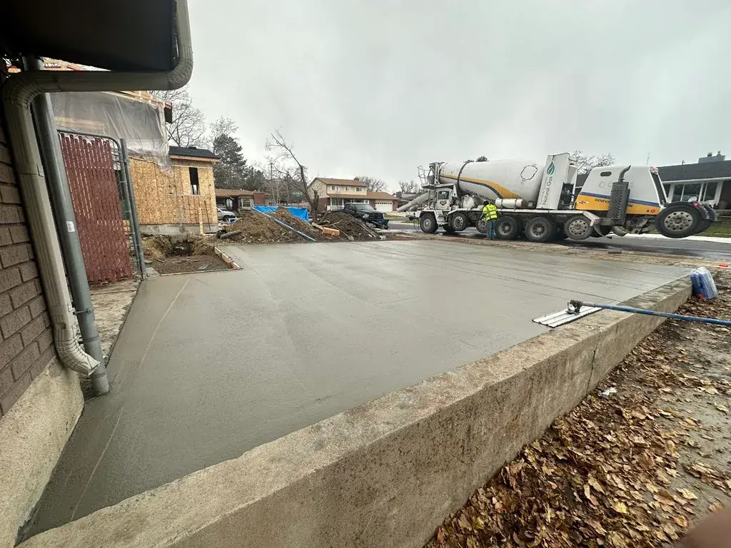 Fresh slab with the mixer truck nearby by MD Concrete in Utah