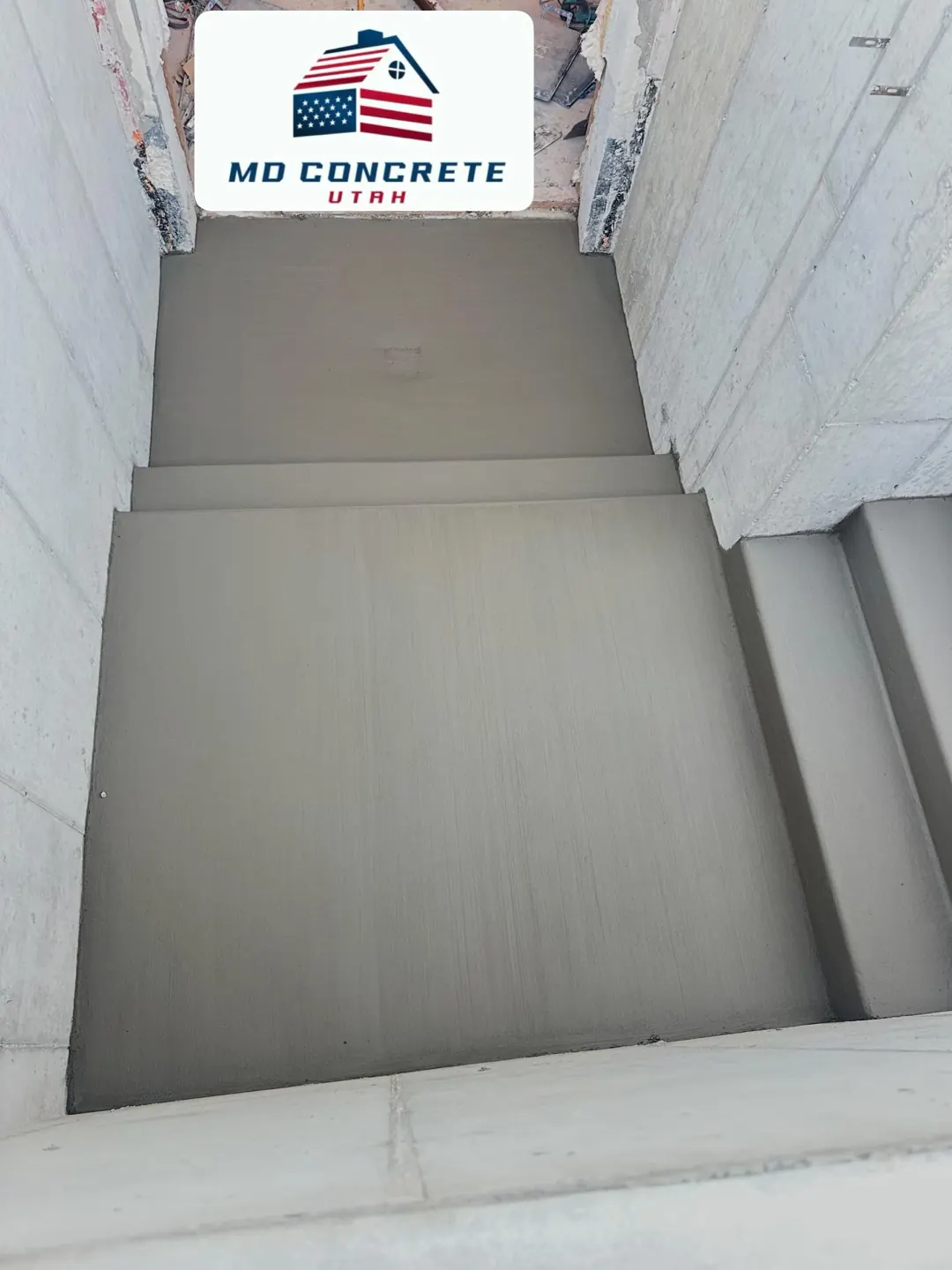 Finished landing at the bottom of the stairs by MD Concrete in Utah