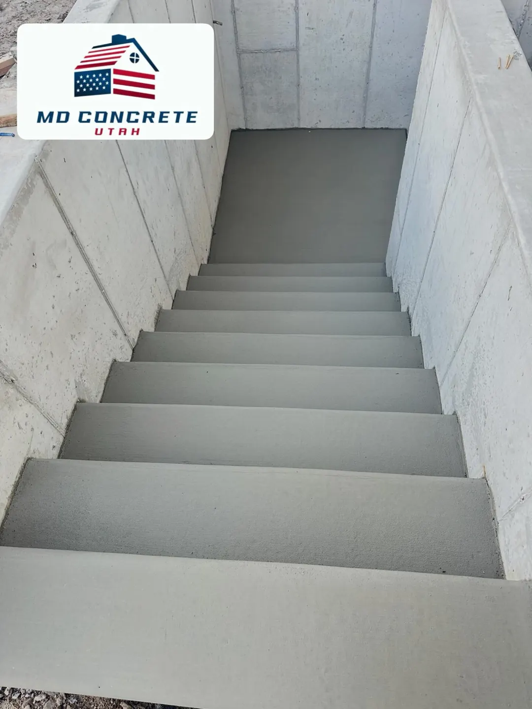 Concrete stairs down to a basement by MD Concrete in Utah